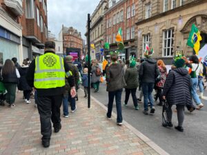 Security guard walking alongside a parade